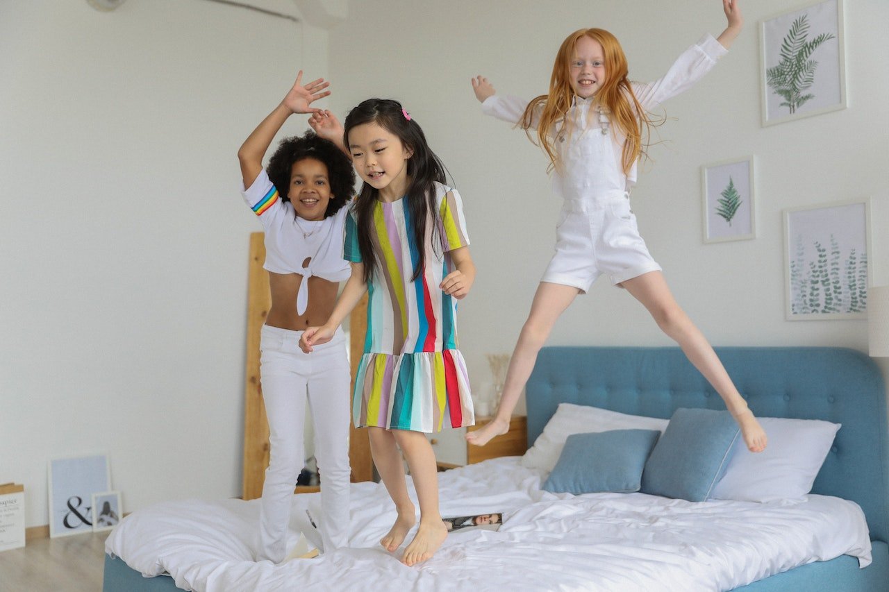 Kid jumping on bed